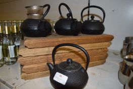 Four Infusion Teapots and Five Wooden Stands