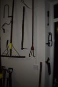 Items on Wall; Rake, Flexible Drill, Saw, Three-Prong Cultivator, etc.