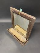 An AA wall hanging mirror with brush compartment.