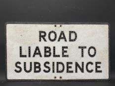 An aluminium road sign for Road Liable To Subsidence, with holes for reflective beads, 30 x 16 3/