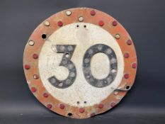 A 30 mph circular road sign with integral reflective discs, 24