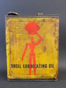A Shell Lubricating Oil rectangular gallon can with robot/stick man motifs.