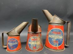 A graduated group of three Price's Motorine oil measures from quart to half pint.