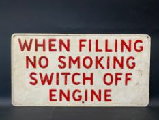 A garage forecourt pressed metal sign 'When Filling No Smoking...', 23 x 12