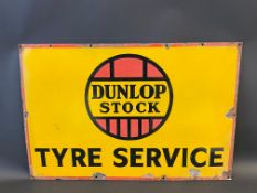 A Dunlop Stock Tyre Service rectangular enamel sign, 30 x 20