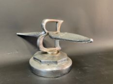 A Bentley winged B radiator mascot on a display base, made from a wheel nut.
