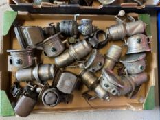 A box of cycle oil and carbide lamps.