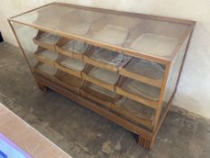 An Edwardian light oak shop counter habidashery type cabinet with pull out drawers to the rear,