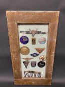 A framed and glazed group of car radiator badges including Lea-Francis, Alvis and MG.