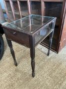 A freestanding display cabinet with fold down access panel to one end, 24 1/2