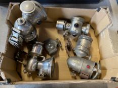 A box of cycle oil and carbide lamps.