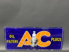 A small AC Oil Filters and Plugs enamel sign with central spark plug image, 21 x 9