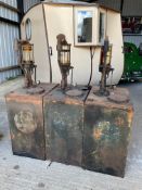 Three garage forecourt bulk oil drums, with original orange paint visible, probably Pratts.