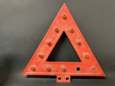 An aluminium triangular warning sign with integral red glass bead reflectors, 18 x 17 1/2