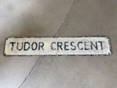 A street name sign for Tudor Crescent, 48 x 9