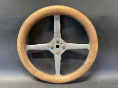 An Edwardian wooden rimmed four spoke steering wheel, overall 14 1/2