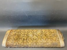 A large carpet covered footwarmer.