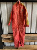 A pair of race waterproof pit overalls, bearing Texaco Heron Team Suzuki badge.