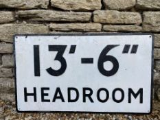 A metal road sign warning of a 13ft 6