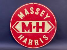 An aluminium circular sign advertising Massey Harris, 21