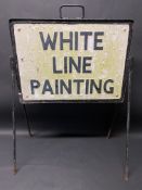 A road sign warning of White Line Painting, on a stand, 23