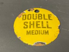 A small circular enamel brand tag for Double Shell Medium, 2 3/4
