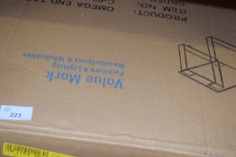 Omega end table with stainless steel legs and a clear glass top