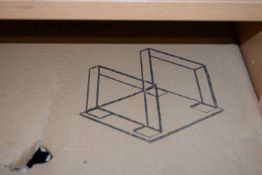 Omega end table with stainless steel legs and a clear glass top