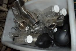 Crate containing a large mixed quantity of glass and stainless steel milk jugs together with pump