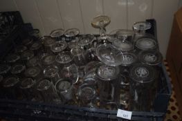 Crate of mixed glass ware to include branded Woodfordes half pint glasses, Stella Artois pint