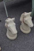 Pair of composite garden statues formed as horses heads, height 50cm