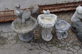 Three small composite garden bird baths, the tallest being approx 60cm