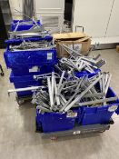 A number of boxes containing metal wall hangers and shop fittings