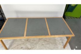 Wooden table, three square grey boxes within