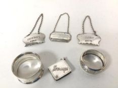 Three silver bottle labels, one Sherry, one Port and one Presentation label, two napkin rings and