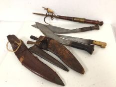 Two WWII period kukris, in leather scabbards and a bone handled steel blade Dah style dagger and