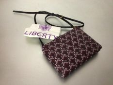 A Liberty of London two section lady's cross body handbag, the two sections with zipper closure,