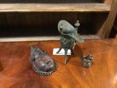 A small African bronze decorative mask, possibly baule, cast with bulging eyes and elaborate head