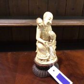 A Japanese carved ivory okimono, late 19thc depicting a smiling seated buddhist monk holding
