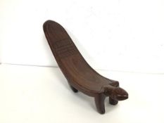 A modern carved African stool of animalistic form (26cm x 38cm x 12cm)