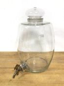 A glass whisky barrel with glass stopper top, remnants of inscription, with metal tap on cork (