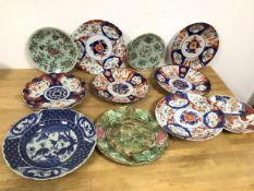 A collection of seven Imari dishes, two dishes with a light green ground and floral and animal