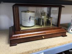 A barograph, manufactured by Russell, Norwich housed within a case with glass to top and sides above