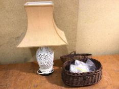 A Chinese pierced ceramic table lamp (49cm to top of shade), a wicker fishing creel with quantity of