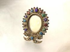 A small gilt-metal and enamel photograph frame, the oval aperture within a wirework frame applied