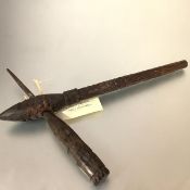 Papua New Guinea, a carved wooden sago pounder, decorated throughout with geometric bands. 47cm by