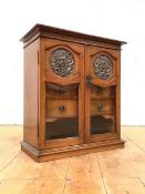 An oak table-top smoker's cabinet in the Art Nouveau taste, c. 1910, the two panelled and glazed