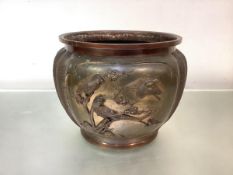A Japanese bronze jardiniere, Meiji period, circular, the lobed body decorated in relief with a pair