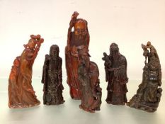 A group of six Chinese carved buffalo horn figures, 19th and 20th centuries, comprising: a