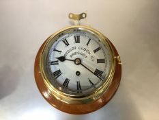 An early 20th century Prescot Clock Co. brass bulkhead clock, with eight-day movement, white